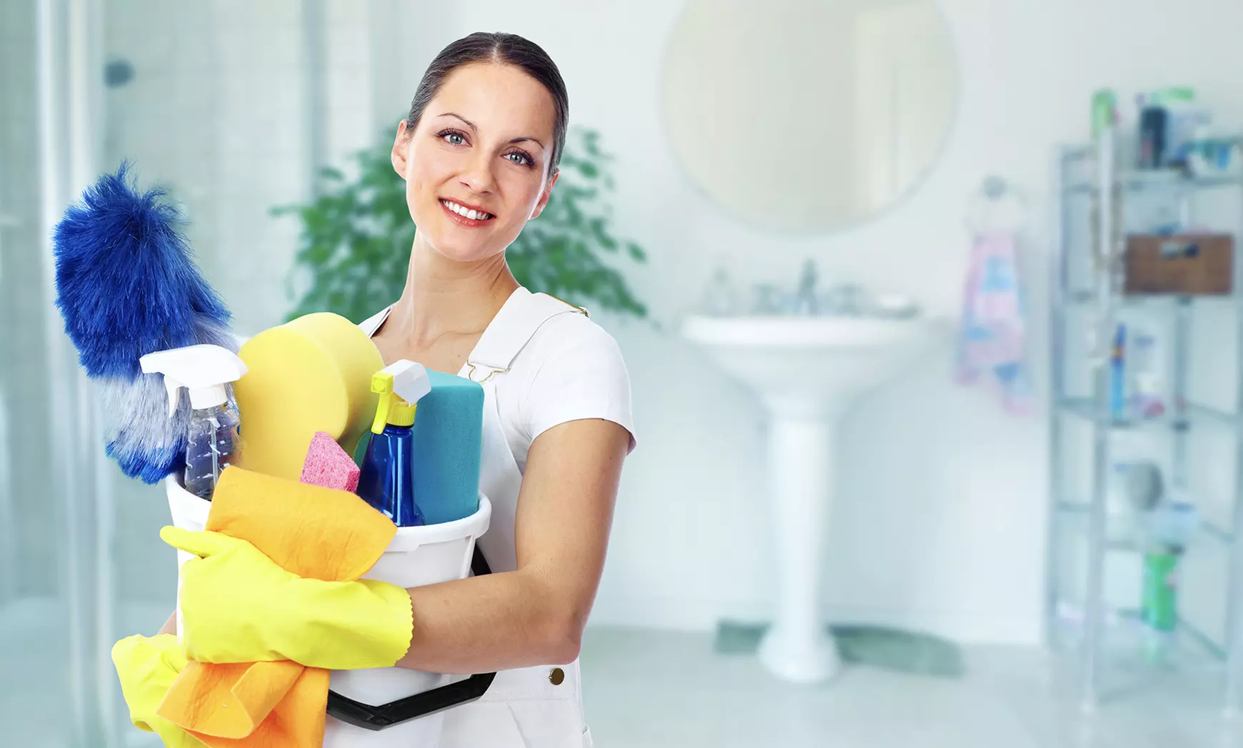 A home cleaning services member girl is satnding with her working equipment.