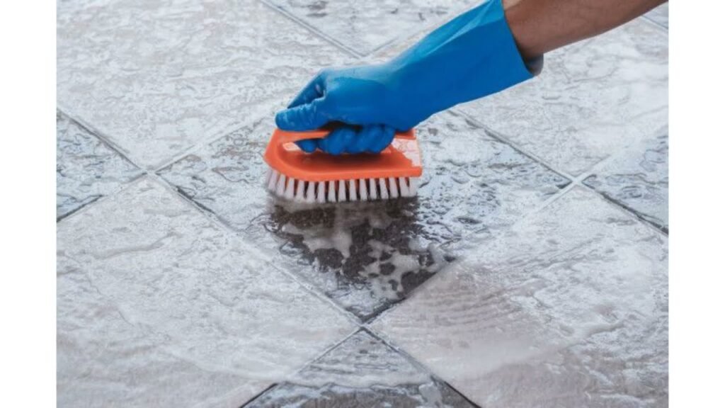 Before and after home cleaning of dirty grout lines in kitchen floor